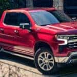A red 2025 Chevy Silverado 1500 Z71 parked on a driveway.