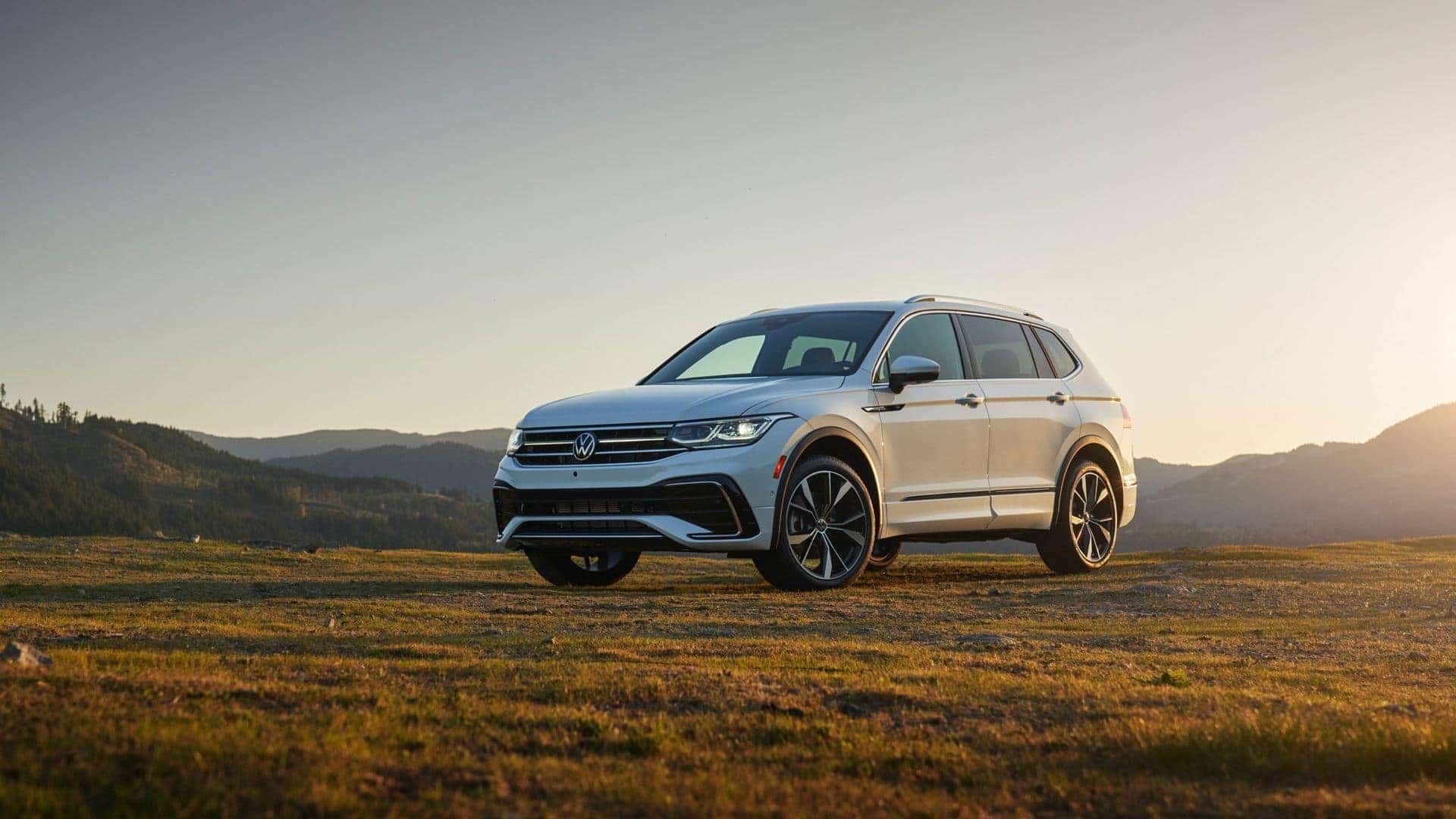 "White 2022 Volkswagen Tiguan parked on grassland."