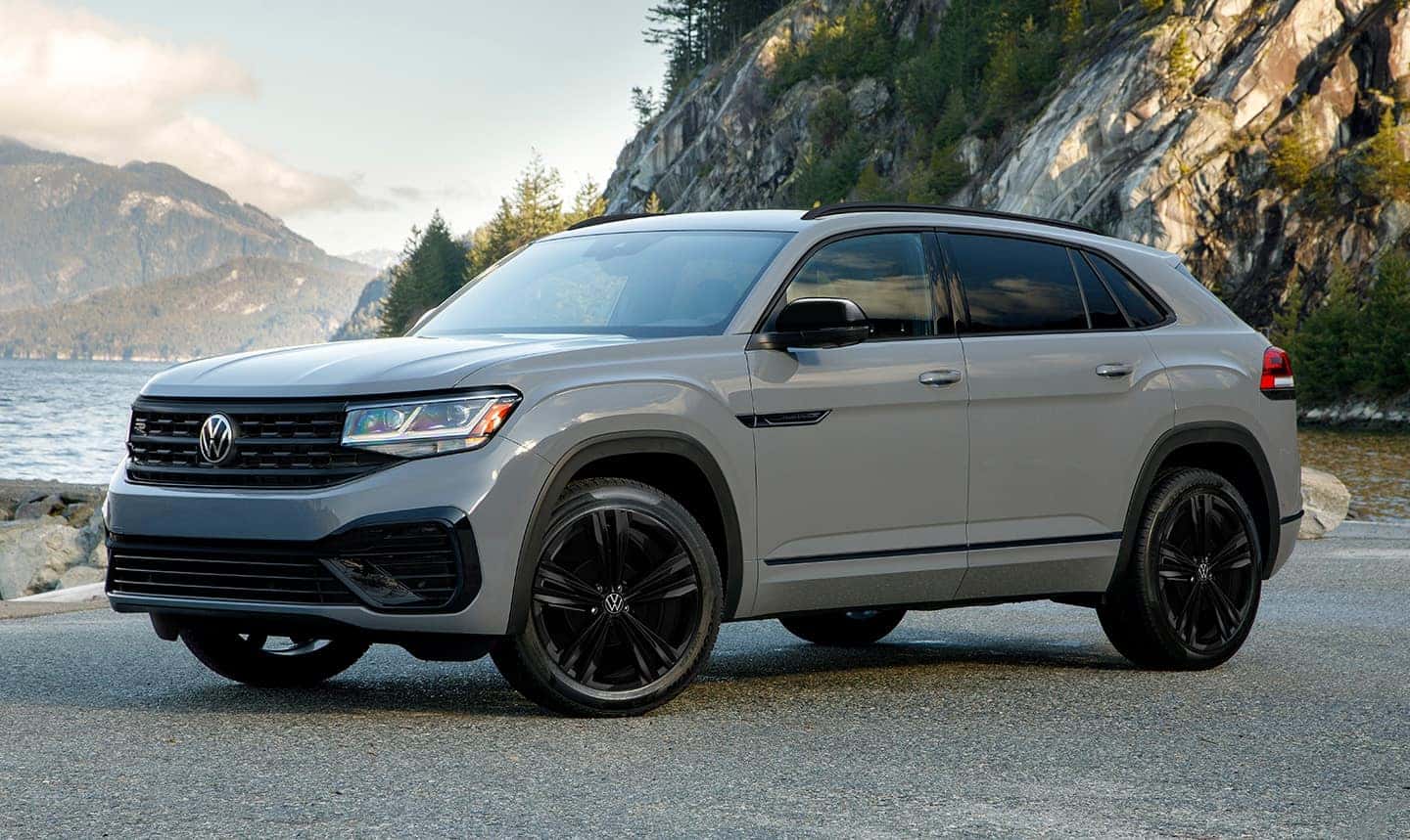 2023 Volkswagen Atlas Cross Sport parked outside near mountains.