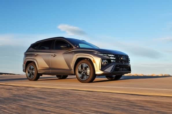 grey hyundai tucson driving on road