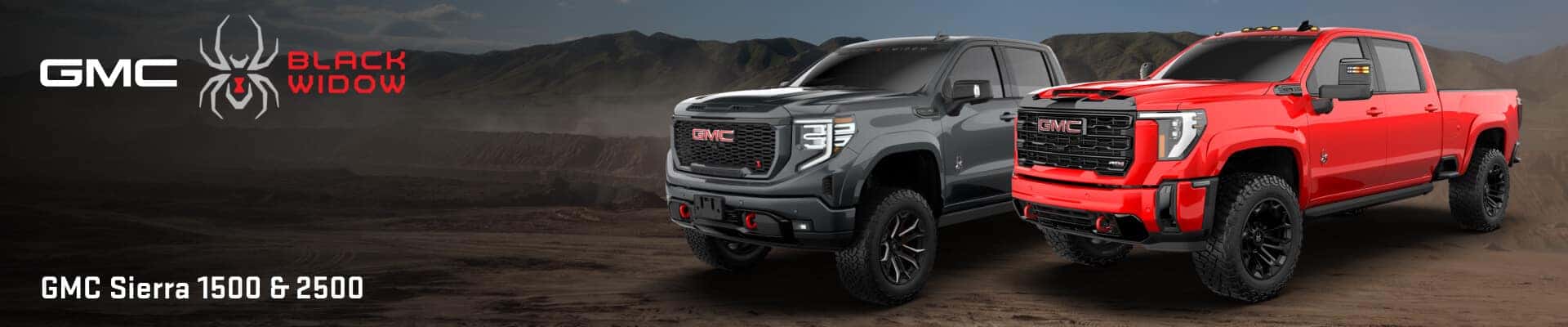 Front three-quarter view of dark gray GMC Sierra 1500 and red Sierra 2500 Black Widow trucks on dirt terrain.