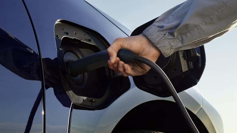 Toyota electric vehicle charging port being plugged in