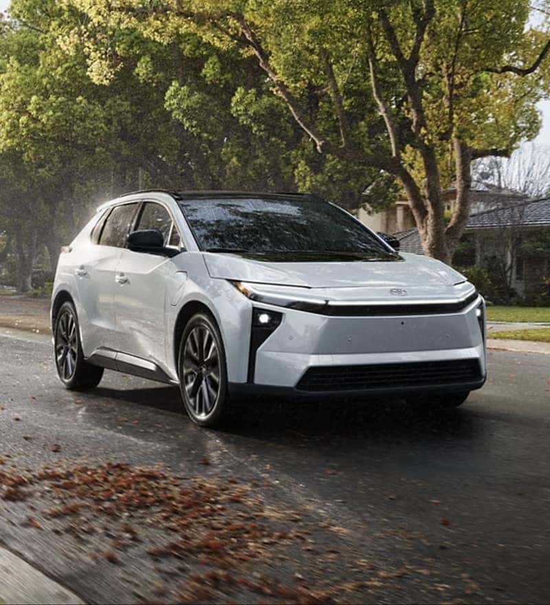 2026 Toyota bZ electric SUV driving through a neighborhood