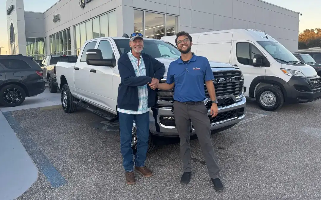 Man and Sales Rep at Jim Browne CDJR standing in front of newly bought RAM