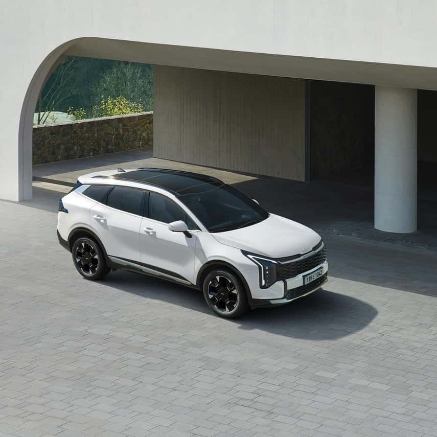 Modern White SUV Parked Under Concrete Structure