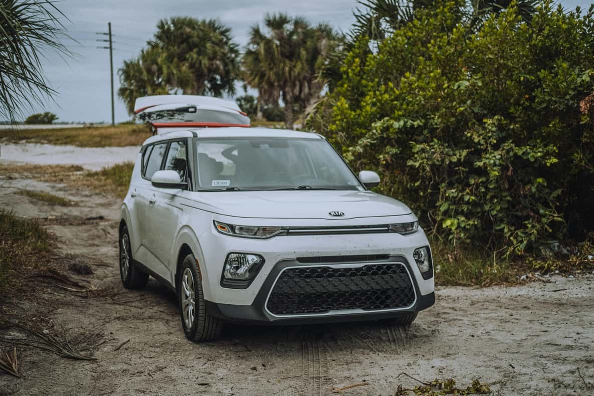 White Car Parked on Dirt Road
