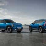 two blue suvs side by side in a parking lot