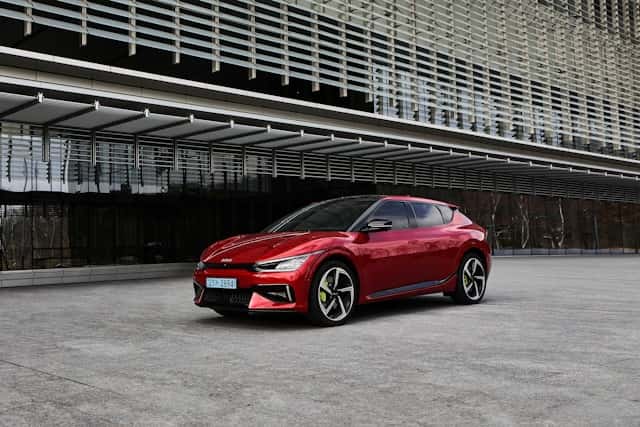 a red car parked in front of a building