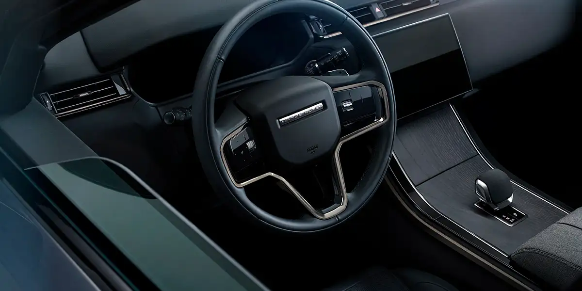 Interior of the 2026 Range Rover Velar with steering wheel and center console