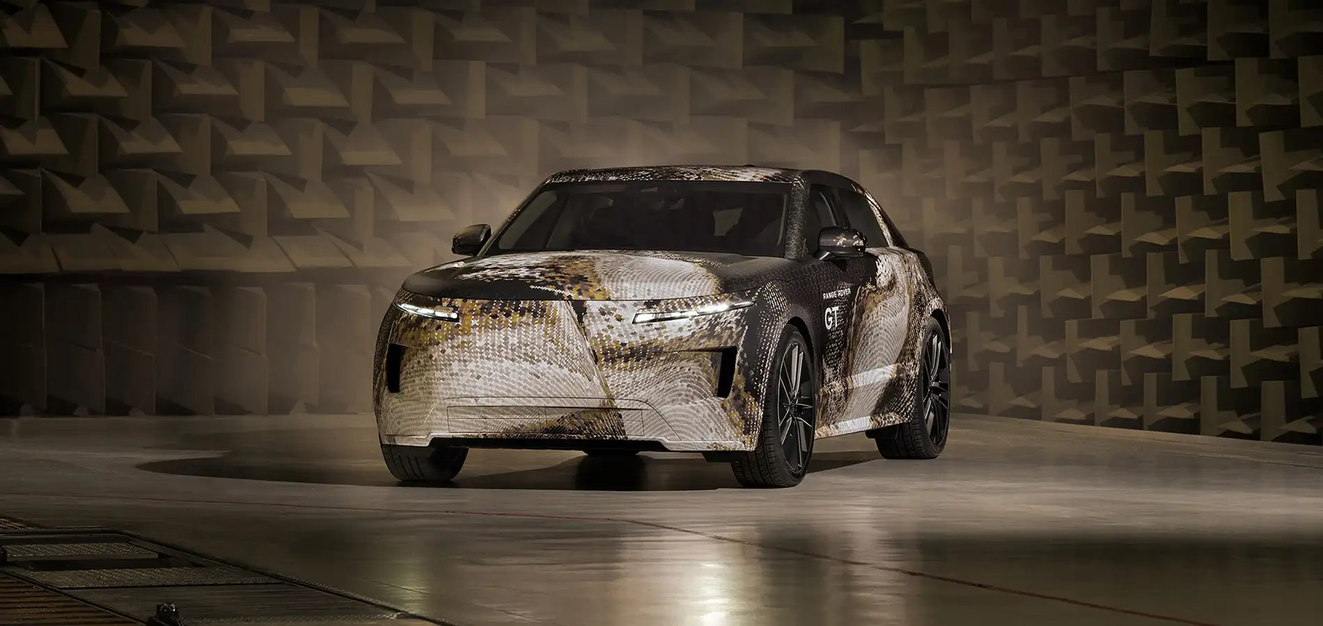 Camouflaged Range Rover GT prototype shown from the front three-quarter view
