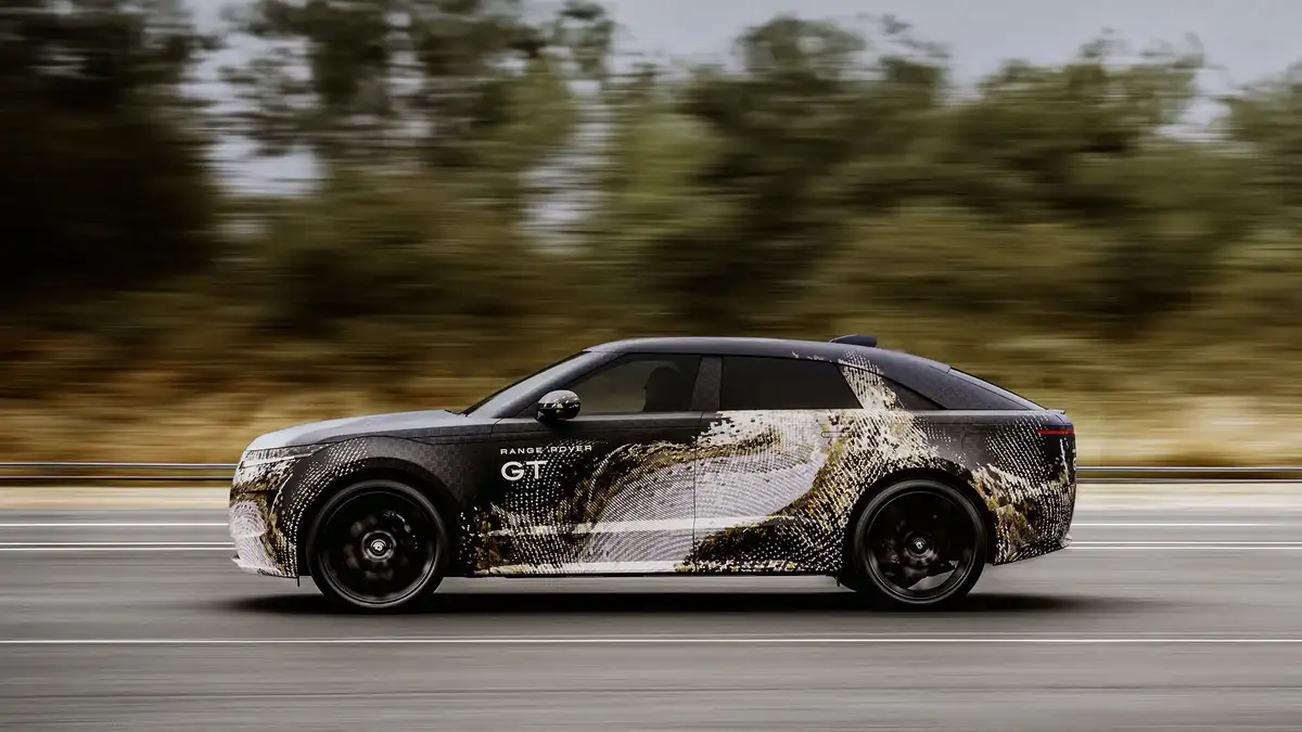 Camouflaged Range Rover GT prototype shown in a dynamic side profile