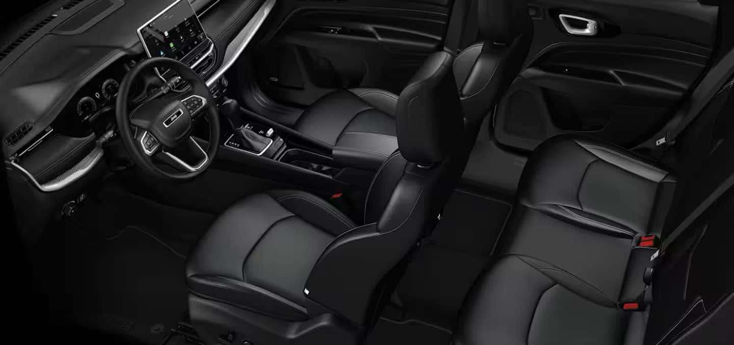 Interior view of the 2024 Jeep Compass featuring black leather seats and dashboard