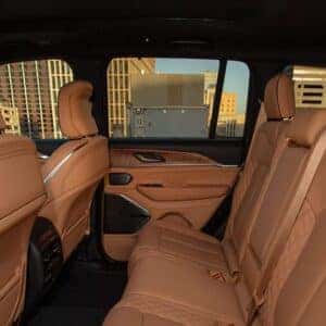 Luxurious second-row seating in the 2025 Jeep Grand Cherokee with tan leather upholstery and ample legroom.