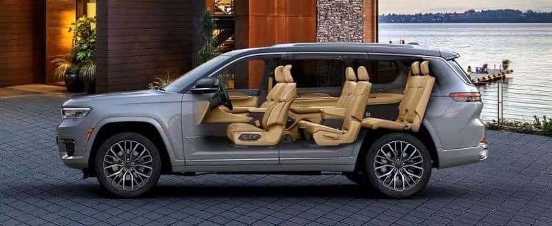 Side view of the 2025 Jeep Grand Cherokee showcasing its three-row seating configuration with tan leather upholstery and ample interior space.