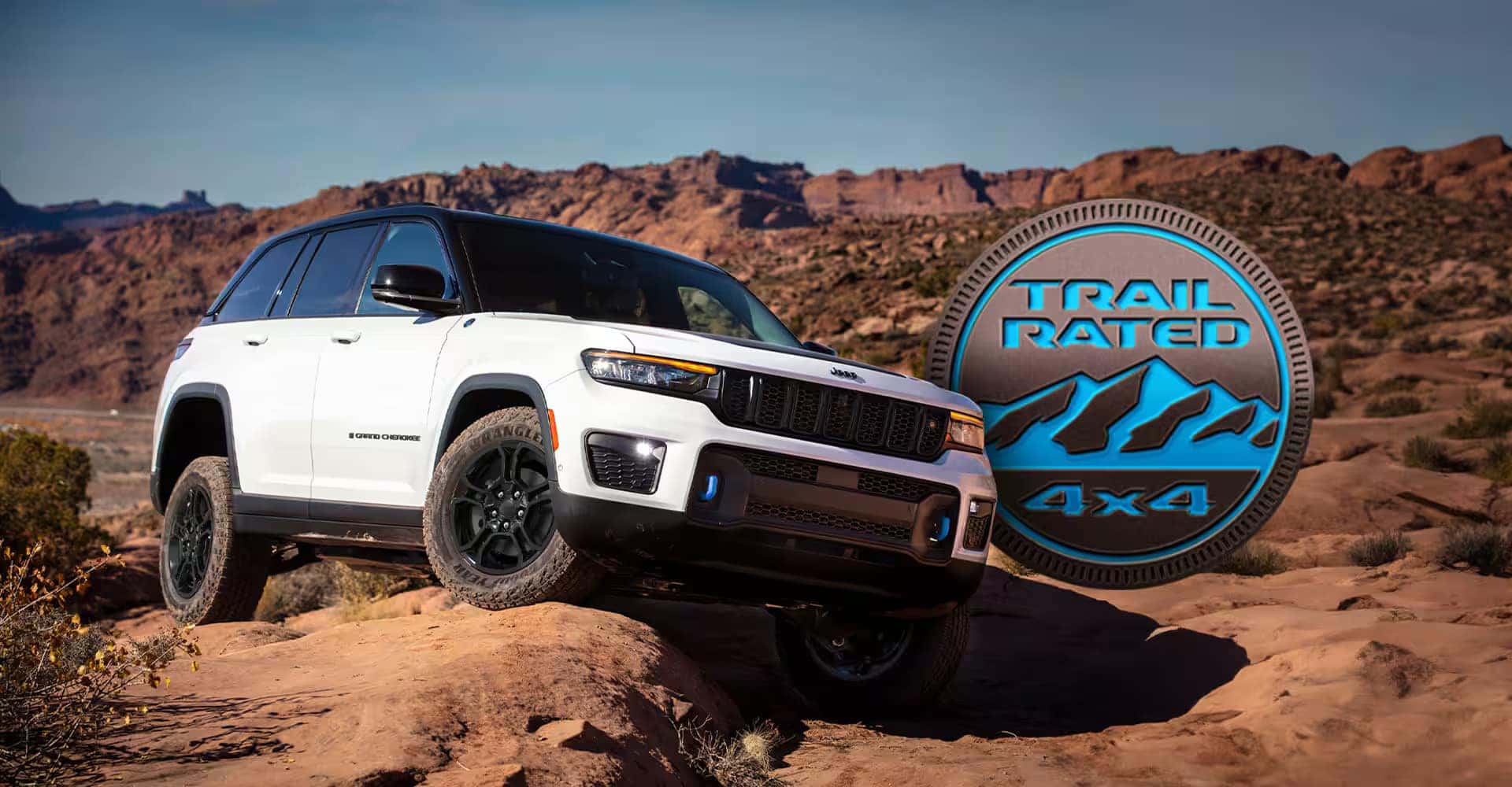 Trail-Rated Jeep Grand Cherokee climbing rocky terrain with Trail Rated 4x4 badge.