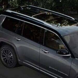 Top view of Jeep Grand Cherokee featuring a sleek black roof design and panoramic sunroof.
