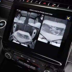 Jeep Grand Cherokee touchscreen displaying live feed from interior monitoring cameras for passenger safety and convenience.