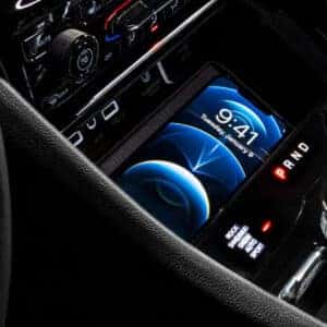 Wireless charging pad in the center console of the 2025 Jeep Grand Cherokee for convenient device charging.