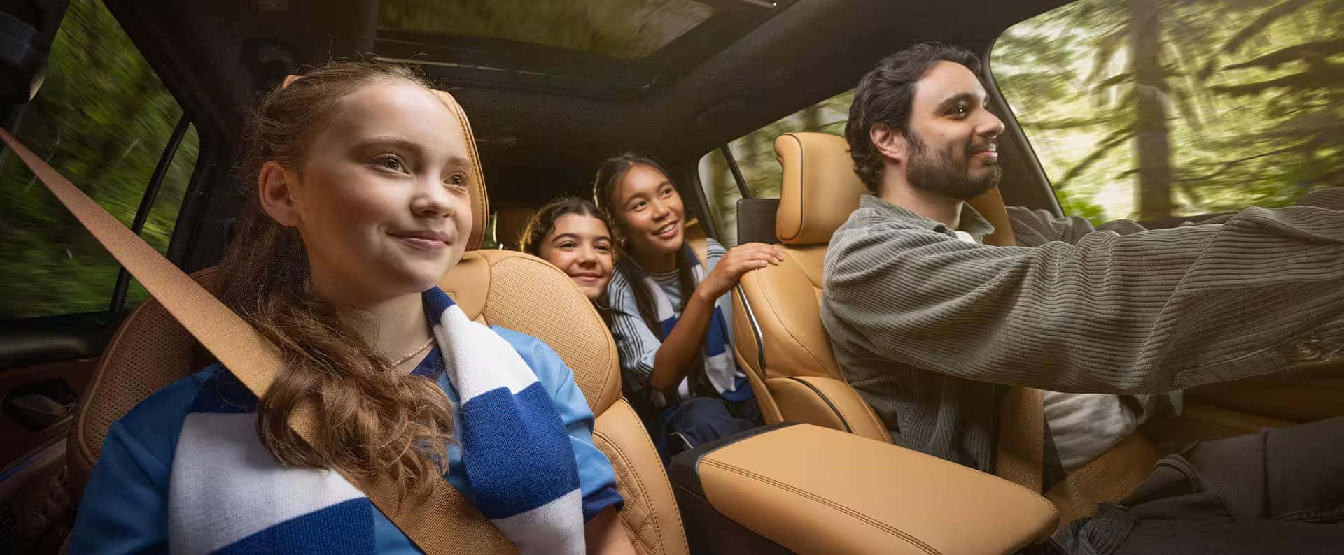 Family riding in the 2025 Jeep Grand Cherokee, enjoying a spacious and comfortable interior with advanced safety features.