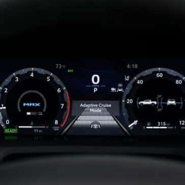 Digital gauge cluster in the Toyota Tacoma displaying adaptive cruise mode and vehicle stats.