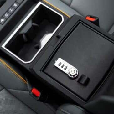 Toyota Tacoma center console with lockable storage and rugged design elements.