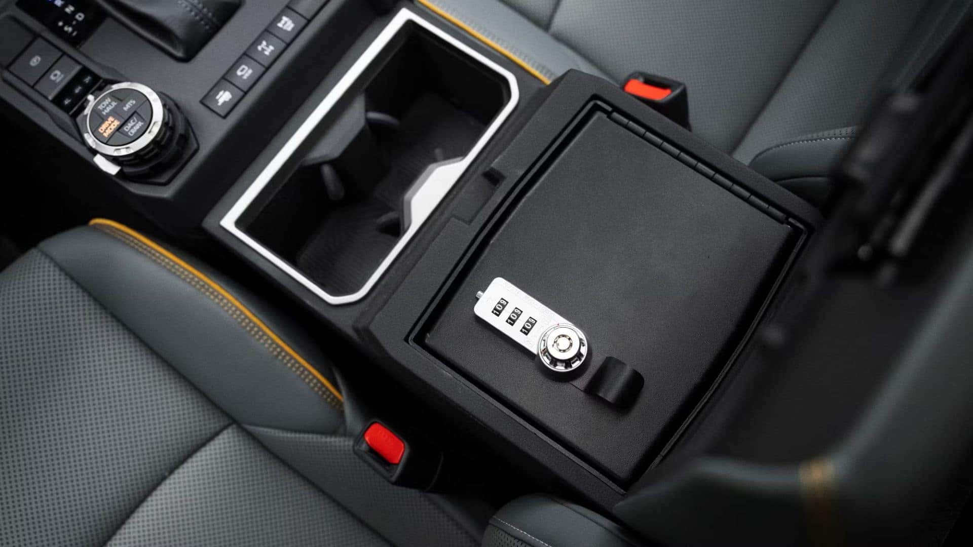 Toyota Tacoma center console with lockable storage and rugged design elements.