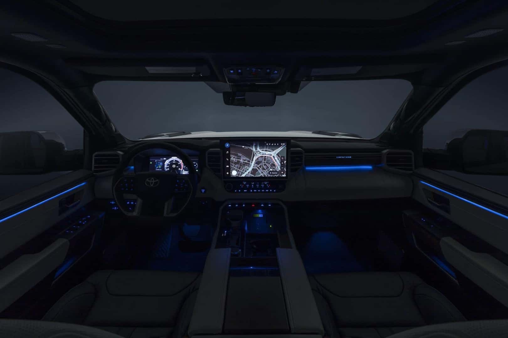 the front interior of a toyota turck with blue accent lights at night