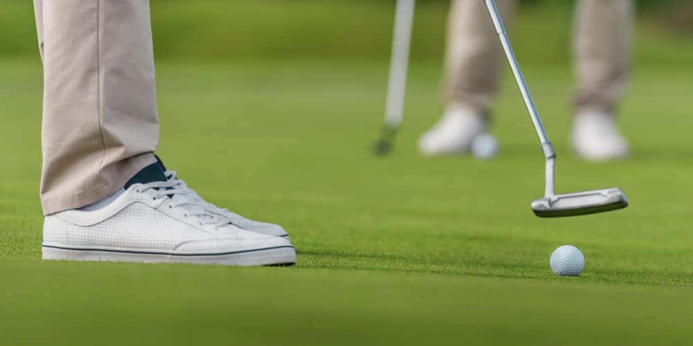 man about to swing at golf ball