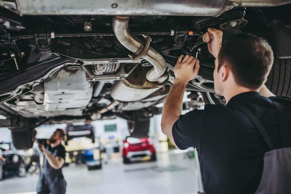 Technician inspecting under the vehicle