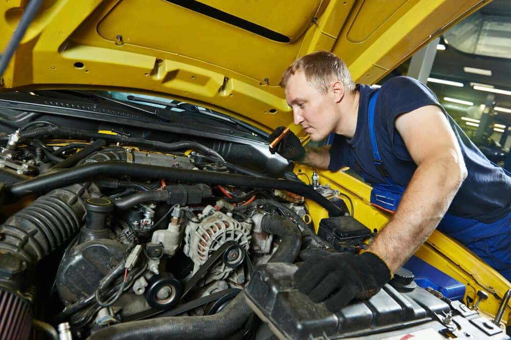 Technician inspecting under the hood