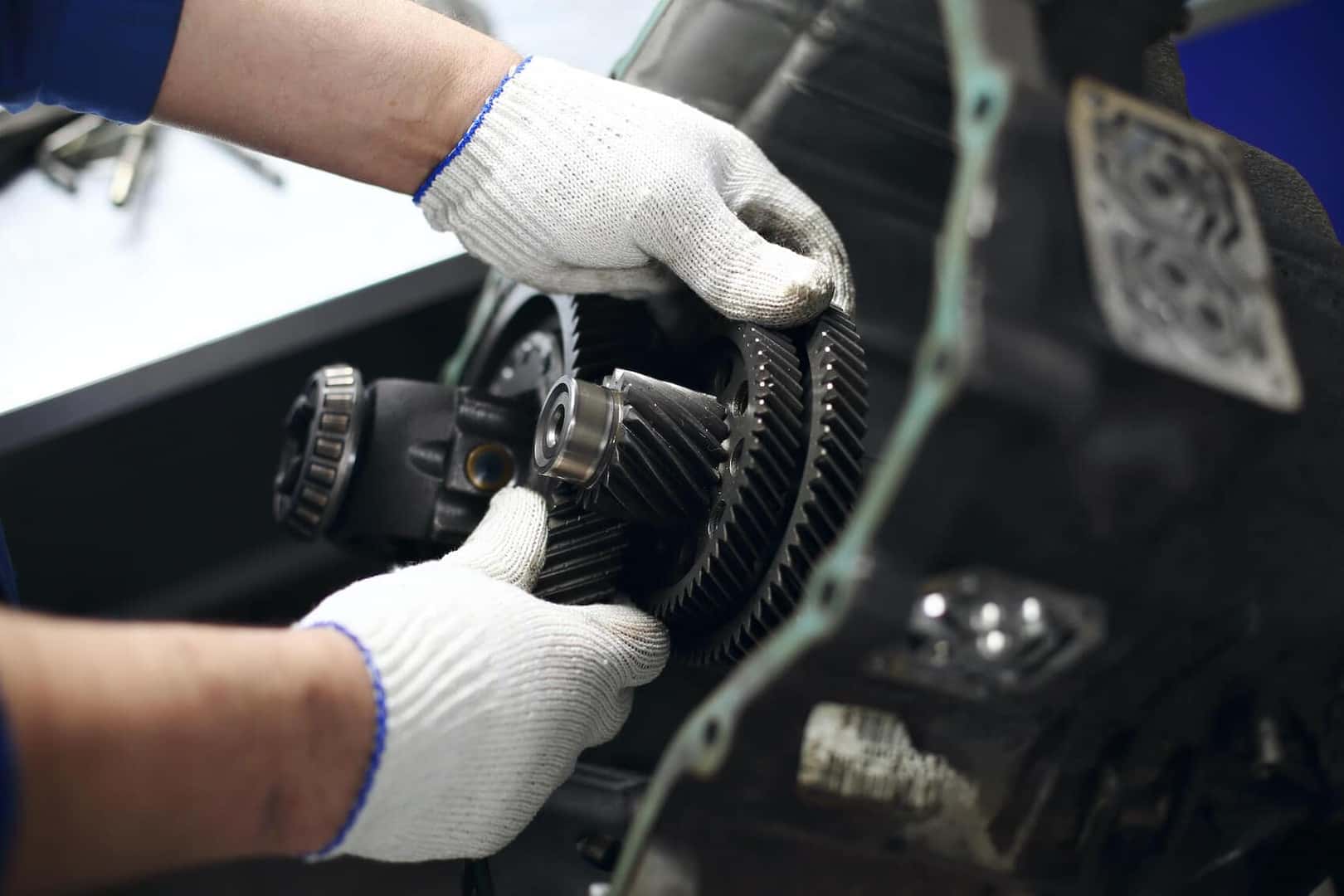 Car techn working on transmission