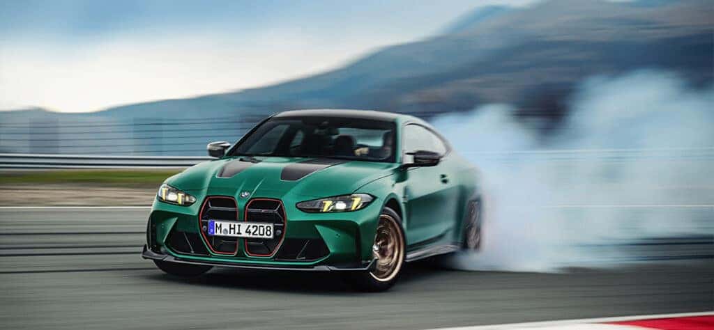 BMW M4 CS drifting on a race track.