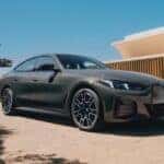 A new 2026 BMW i4 parked in a driveway.