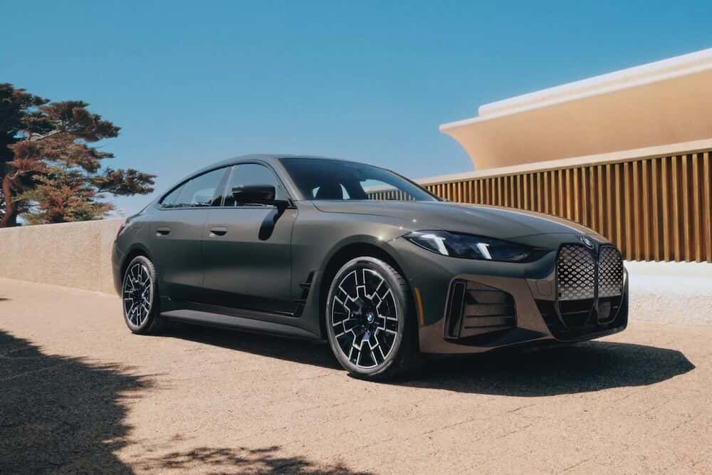 A new 2026 BMW i4 parked in a driveway.