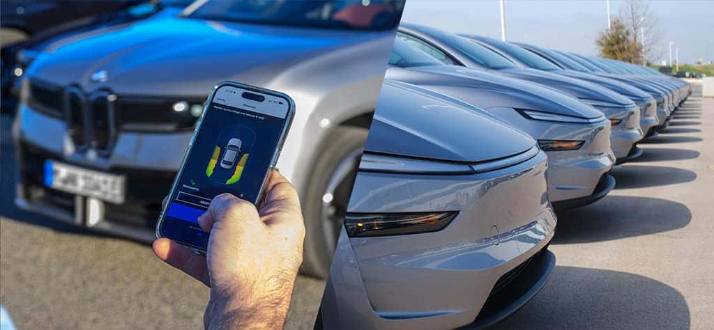A BMW owner using his phone to park his iX3. Several Tesla Model Y's sitting on the lot.