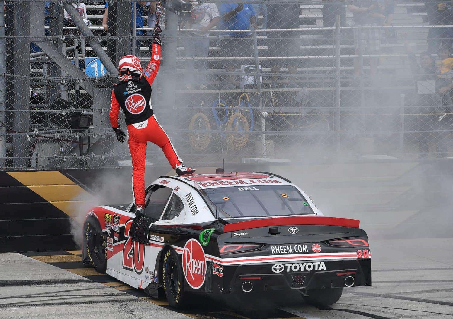 Christopher Bell stands victorious following NASCAR race.