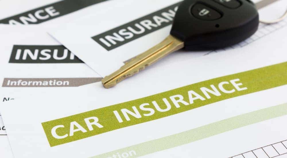 A car key is shown on an insurance form.