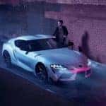 A silver 2022 Toyota Supra is shown from the front at an angle in a dark alley after the owner searched for 'sell my car in Reading.