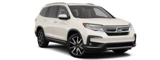 A white 2022 Honda Pilot Touring is shown angled right.