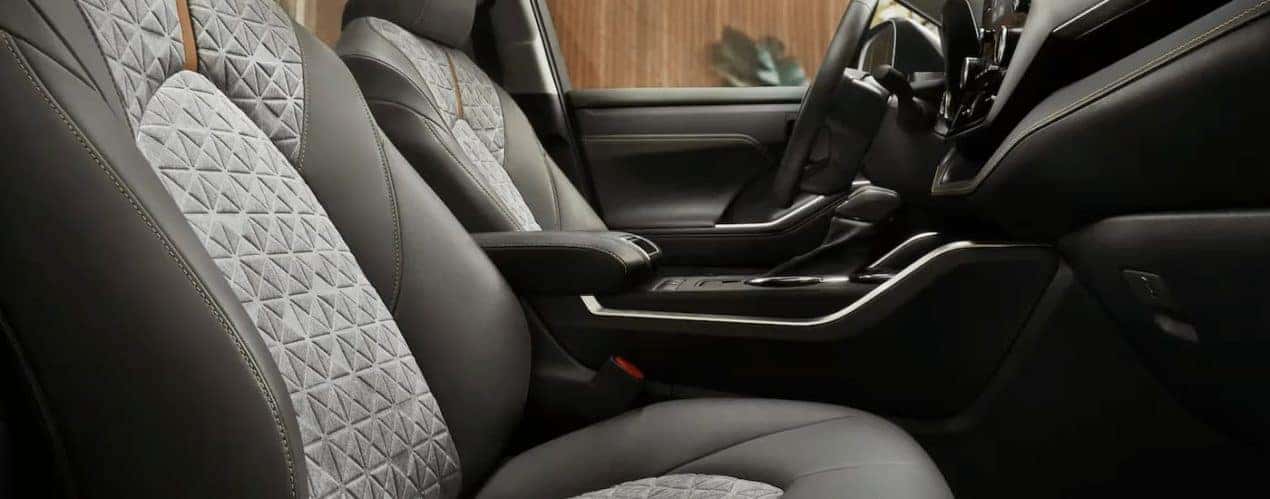 The grey interior of a 2022 Toyota Highlander is shown during a 2022 Toyota Highlander vs 2022 Honda Pilot comparison.