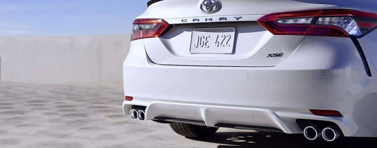 A close up of the trunk of a white 2023 Toyota Camry XSE V6 is shown.