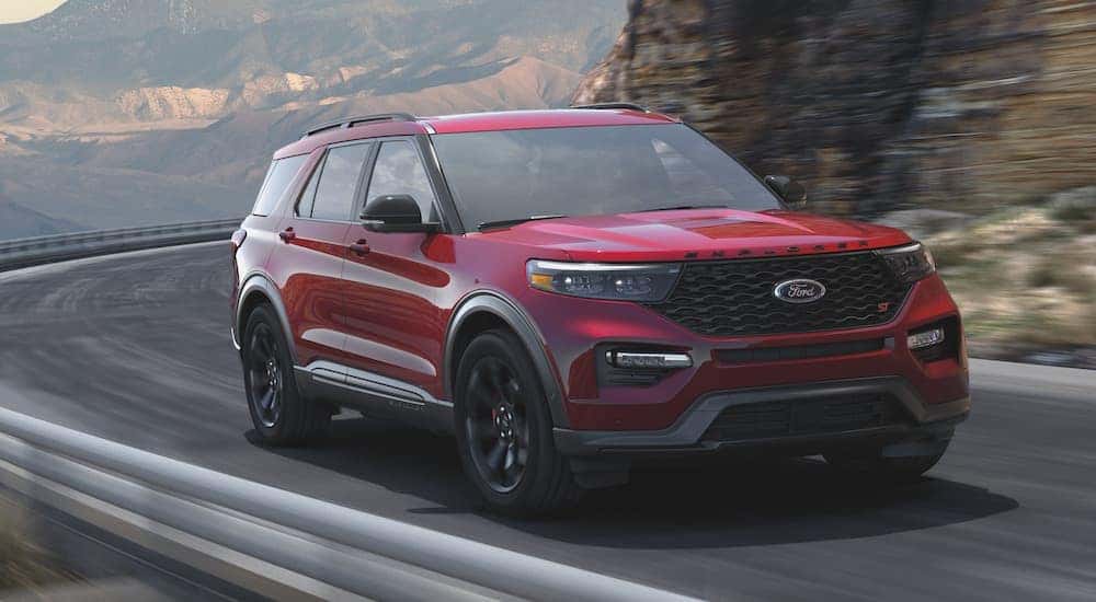 A red 2021 Ford Explorer ST is shown from the front at an angle after leaving a dealer that had used SUVs for sale.