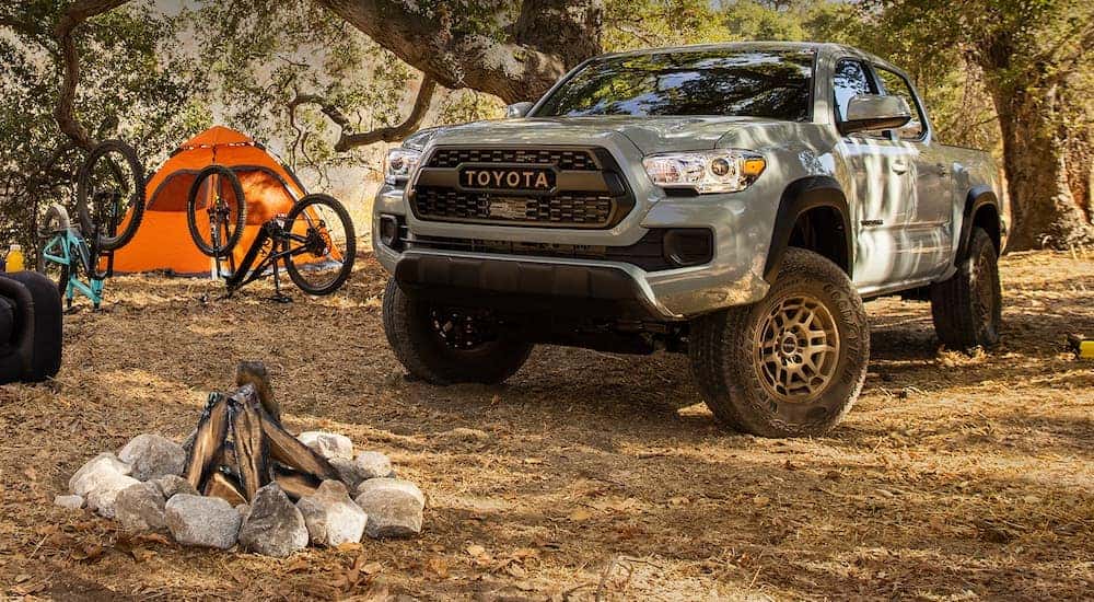 A grey 2023 Toyota Tacoma Trail Special Edition is shown parked at a campsite.