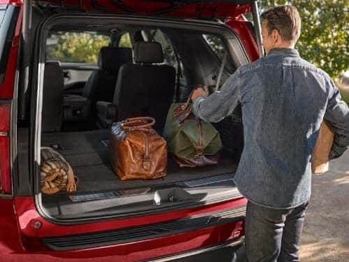 2024 Chevrolet Tahoe view of man loading bags into back cargo area