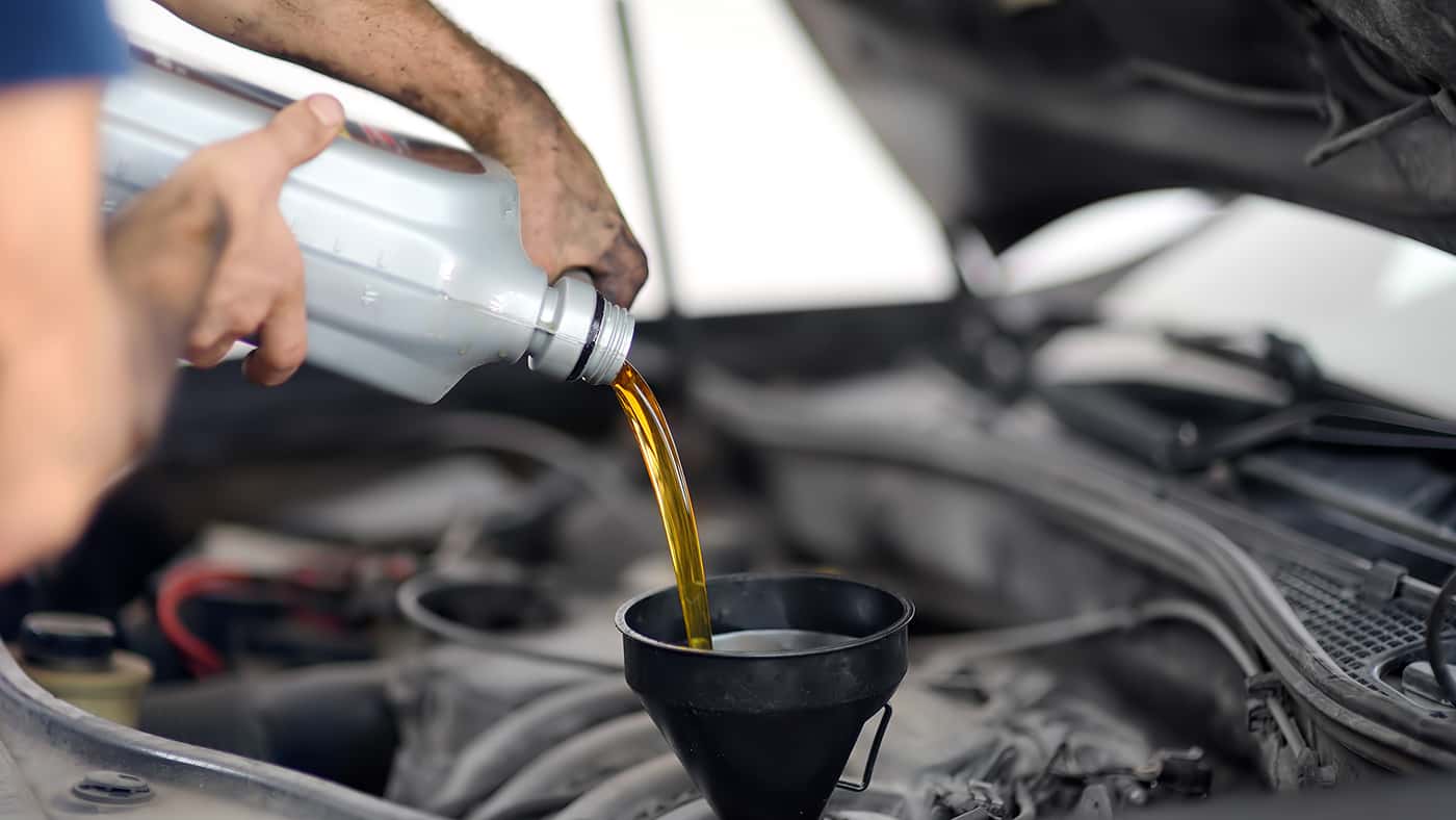 Mechanic Pouring Oil