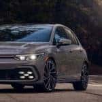 2022 VW Golf GTI driving through misty forest