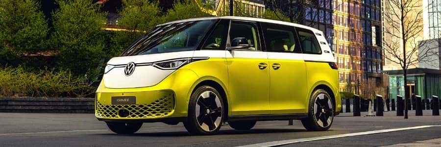 a canary yellow Volkswagen ID Buzz drives in the city