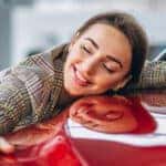 woman hugging a new car