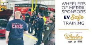 group of first responders surrounding electronic vehicle