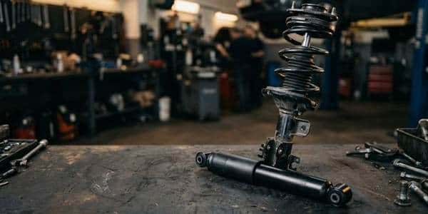 New strut assembly and shock absorber on a service department bench